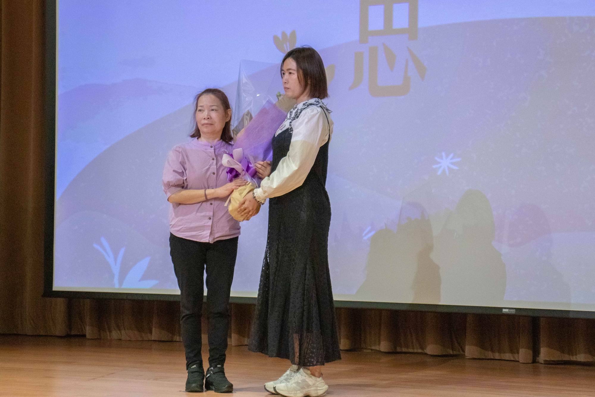 林雅卉護理師(圖右)獻花給黃昀玲女士的母親(圖左)，代表受贈者向捐贈者家屬表達敬意。